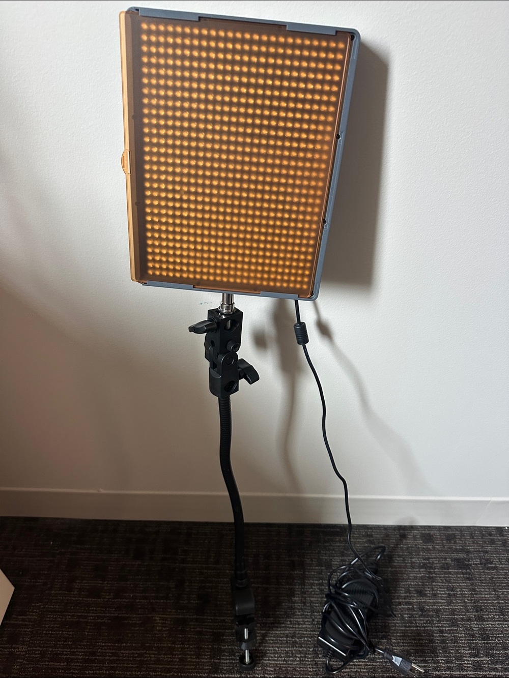 Aputure Amaran HR672W LED Video Light Panel with stand/holder and orange filter.